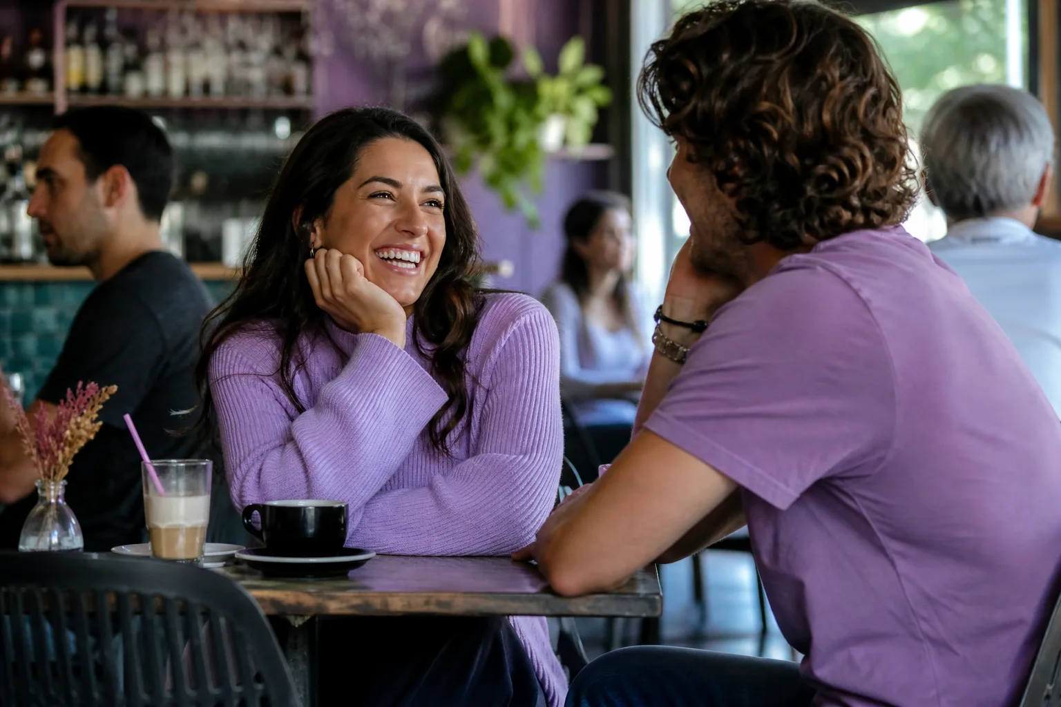 Two adults chatting over coffee at an independent café in Essex